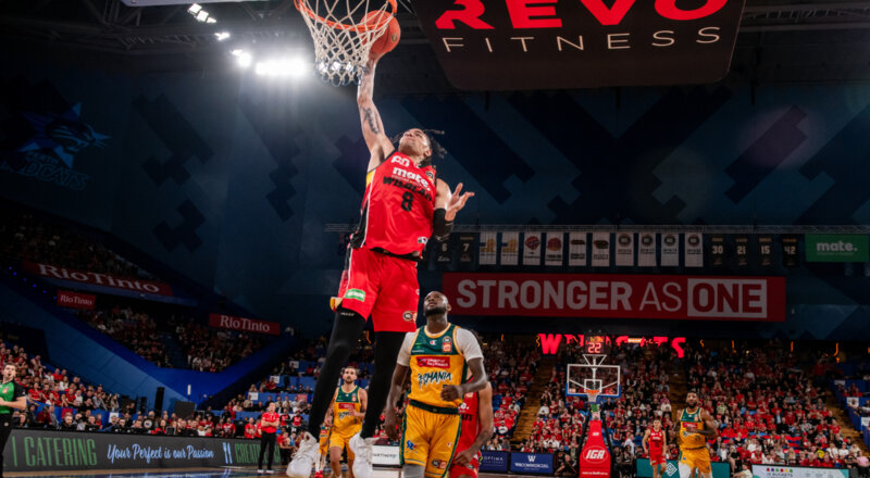 Player Jordan Usher, dunking the ball into the hoop at RAC Arena