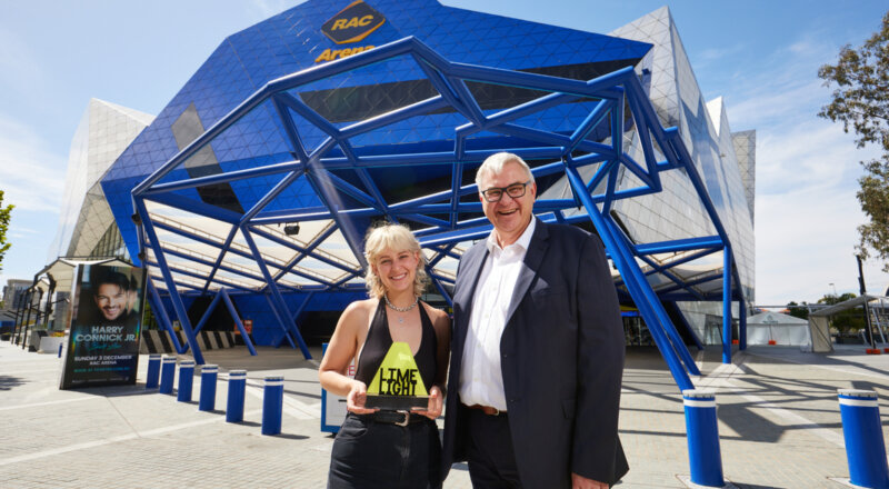 The main prize winner of the 2023 Limelight music support fund, Angie Colman, standing outside RAC Arena with general manager, Michael Scott