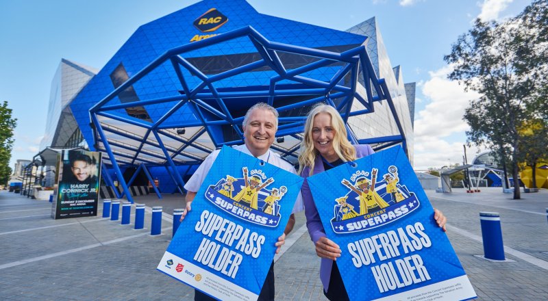 Salvation Army representative alongside a RAC Arena representative standing out the front of the RAC Arena building holding signs that say 'Superpass Holder'