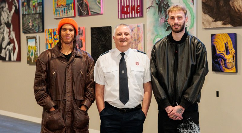 Nelson Mondlane, Warren Palmer and Zac Crawdon standing in front of the Passing By Project exhibition.